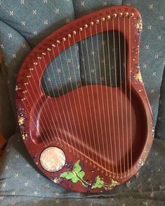 a red harp sitting on top of a blue chair