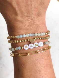 🔹 Design the personalized word bracelet that you have always wanted! These stacking mama bracelets can be personalized so you can get exactly what you want. 🔹Please add each bracelet style separately to your cart. They will be sent to you as a stack.  🔹They are made with 4mm amethyst, rose quartz, howlite, grey agate or aquamarine gemstones beads, 18k gold plated, 18k Gold Filled, Sterling Silver Plated or Rose Gold beads and then strung together with a strong double- strung elastic cord. The paperclip chain bracelet is 18k gold plated. Bead color may vary slightly. Gold filled beads have a much thicker gold coating and will last for years.  🔹Each stackable set makes the perfect gift for yourself or for Christmas, a baby shower, new mom, Mother's Day, bridal shower, birthday and Valent Meaningful Letter Beads Jewelry For Mother's Day, Personalized Cute Gold Beaded Bracelets, Meaningful Letter Beads Bracelets For Mother's Day, Customizable Meaningful Bracelets For Everyday, Mother's Day Meaningful Bracelets With Letter Beads, Inspirational Jewelry With Round Beads For Mother's Day, Inspirational Round Beads Jewelry For Mother's Day, Inspirational Round Beaded Jewelry For Mother's Day, Personalized Name Bracelet With Round Beads