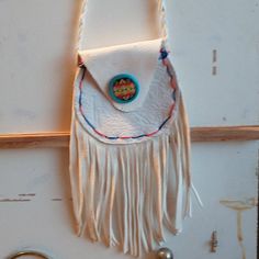 Small Native American White Fringed Pouch. Made With Buckskin And Buffalo Skin. Red And Blue Satin Stitching And Twisted White Fringe Handles. Native American Style Cobachon Adorns The Flap. Small Magnetic Closure. New And Handmade. About 18 Inches Including Handle And Fringes. About 4 Inch Circle Pouch. #Authentic #Nativeamerican #Handmade White Crossbody Shoulder Bag As Gift, White Crossbody Shoulder Bag For Gift, White Pouch Shoulder Bag For Personal Use, White Coin Purse With Removable Pouch, White Coin Purse With Removable Pouch For Everyday Use, White Leather Pouch With Removable Pouch, White Adjustable Bag As A Gift, White Adjustable Rectangular Shoulder Bag, White Shoulder Bag With Adjustable Strap As Gift