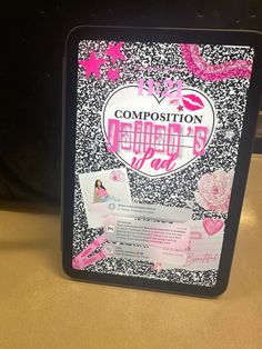 a black box with pink and white designs on it that says composition beauty bar in the center