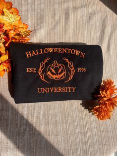 Halloweentown University embroidered crewneck sweatshirt Our sweatshirt are 50% cotton & 50% polyester  This sweatshirt is one of the cutest Halloween sweatshirts ever! Our sweatshirts are well embroidered and folded for our customers! This is a super cute sweatshirt for the Halloween holiday and as a Halloween gift 🎁  If you have any question feel free to contact us! Fall School Spirit Crew Sweatshirt, School Spirit Crew Sweatshirt For Fall, Fall Crew Sweatshirt With School Spirit, Fall School Spirit Sweatshirt With Embroidered Graphics, Fall School Spirit Embroidered Sweatshirt, Black Sweatshirt With Custom Embroidery For Fall, Fall School Spirit Sweatshirt With Custom Embroidery, Custom Embroidered Sweatshirt For School Spirit In Fall, Fall College Sweatshirt With Embroidered Text