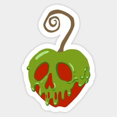 an apple with green and red spooky paint on it's face, sitting next to a spiral sticker