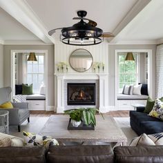 a living room filled with furniture and a fire place in the middle of a room