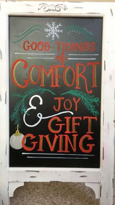 a chalkboard sign that says good things to comfort and joy gift giving on it