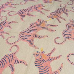 a pink and blue tiger print fabric on a bed