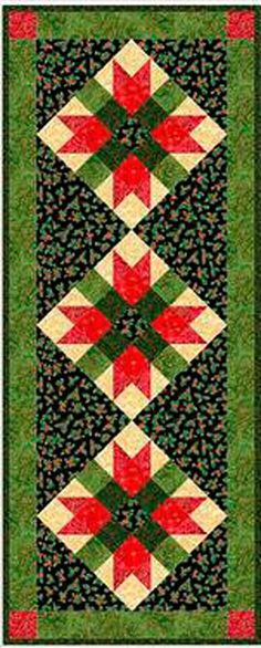 a green and red quilt with an intricate design on the front, back and sides