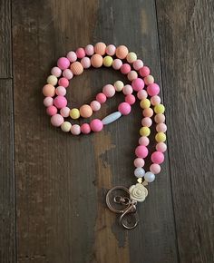 🌈Pastel sunset silicone bead Lanyard! This Sunset lanyard is made with soft silicone pastel beads in pink, orange and yellow. Made with a large light gold lobster clasp, and rose focal pendant. This lanyard is closed with a white breakaway clasp.  Perfect lanyard for pediatric health care professionals, teachers, and anyone who loves pastel Sunset colors!  Excellent gift for teachers appreciation day!  It's made in a standard 18-19" length, but that can be adjusted upon request! Just message me Bead Lanyard, Lanyard Teacher, Teachers Appreciation, Pastel Sunset, Pastel Beads, School Supply, Beaded Lanyards, Pink Sunset, Sunset Colors