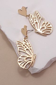 Our Butterfly Symmetric Earrings are a stunning blend of elegance and whimsy. These captivating earrings feature a unique design with one side showcasing a delicate heart and the other a graceful butterfly wing, symbolizing love and freedom. Our earrings are versatile enough for both casual and special occasions. Product Details:Length: 2"Width: .75 Earring back: Titanium PostMetal finish: gold PlatingProduct: Lead & Nickel CompliantAnti-tarnish: Double E-coating The titanium posts ensure durability and hypoallergenic wear, making them suitable for sensitive ears.Hypoallergenic postSurgical steel postLightweight postDurable post Minimalist Gold Butterfly Earrings | Butterfly Earrings | Gold Jewelry | Half Butterfly Earrings | Fashion Jewelry | Trendy Jewelry | Butterfly Wings | Gold Dangle Half Butterfly, Gold Butterfly Earrings, Clay Inspo, Jewelry Butterfly, Butterfly Earrings Gold, Heart Butterfly, Earrings Butterfly, Butterfly Wing Earrings, Post Metal