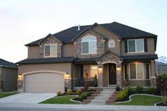 a large house with two garages in front of it