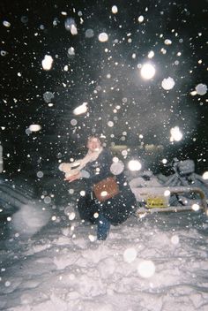 a person walking in the snow at night