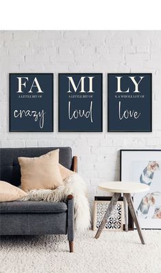 three black and white posters on the wall above a couch in a living room with pillows