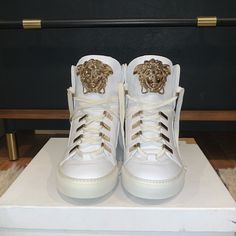 Versace High Top Sneakers. White Leather Upper, Rubber Sole, Gold Hardware. Brand New And Never Worn. Laces On Right Shoe Have A Few Marks, See Last Pick. Original Box, No Dust Bag. Size 37.5 I’m A True 7 And They Fit Perfect With A Little Room. Luxury Leather Sole High-top Sneakers, Luxury High-top Sneakers With Leather Sole And Round Toe, Designer High-top Sneakers With White Sole And Laces, Luxury White High-top Sneakers With Laces, Luxury White High-top Sneakers With Leather Sole, Designer White High-top Sneakers With Leather Sole, Designer Gold High-top Sneakers, Designer High-top Custom Sneakers With Laces, Luxury Sneakers With Laces