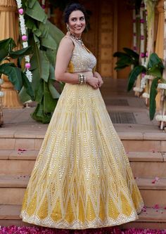 Geometric mirror and leather applique embroidered skirt in silver on yellow dupion silk fabric paired with heavily embroidered blouse and tulle dupatta with scallop border and pearl and sequence detailing. Yellow Indian Lehenga, Designer Yellow Sequin Sets, Yellow Embellished Designer Wear Sets, Designer Yellow Embellished Sets, Yellow Gota Work Sets For Reception, Yellow Embellished Sharara For Navratri, Yellow Embellished Anarkali Set With Traditional Drape, Yellow Embellished Sharara With Traditional Drape, Yellow Organza Sets With Mirror Work