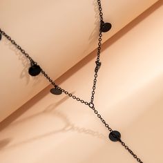 This necklace features a Y-shaped design with disk-shaped accents. Chain: 21.7" L with 5.9" extender 5.9" drop Lobster claw clasp Rhodium-plated copper Jewelry Wardrobe, Black Dots, Lariat Necklace, Black Sequins, Polished Look, Lobster Claw, Rhodium Plated, Modern Style, Tassels