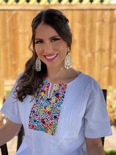 This Beautiful Hand embroidered blouse has a unique and Mexican inspired Floral design. The blouse has a beautiful traditional look to it and is made with fresh Mexican linen. The Jewelry modeled may be purchased here: Filigree Earrings: https://www.etsy.com/es/listing/872372628/filigrana-clasica-de-gota-arete-mexicano?ref=listings_manager_grid Bohemian Blouse With Traditional Patterns For Festivals, Traditional Summer Tops With Traditional Patterns, Traditional Tops With Summer Patterns, Traditional Blouse With Multicolor Embroidery, Traditional Blouse With Embroidered Border For Festivals, White Traditional Tops With Traditional Patterns, Bohemian Blouse With Traditional Patterns For Ceremonies, Traditional Embroidered Short Sleeve Top, Traditional Embroidered Blouse For Festival