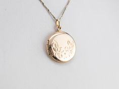 This vintage locket features beautiful floral engravings and has space for two photos, one on the inside of each cover. There is space on the back where a monogram or name can be engraved. Market Square Jewelers works with one of the finest hand engravers in the northeast. With over 30 years of experience, our engraver hand carves lettering, monograms, crests, or patterns in period-specific styles. Choose from our many monogram options shown in the listing or contact us directly with your own cr Vintage White Gold Jewelry With Engraving Option, Engraved Rose Gold Heirloom Locket Necklace, Elegant Engraved Rose Gold Locket Necklace, Heirloom Rose Gold Locket Necklace For Wedding, Engraved Flower Pendant Jewelry For Memorial, Classic Locket Necklace For Wedding, Formal Rose Gold Engraved Locket Necklace, Antique Engraved Locket Necklace With Flower Pendant, Vintage Round Locket Necklace With Engraving Option