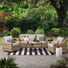 an outdoor living area with furniture and plants