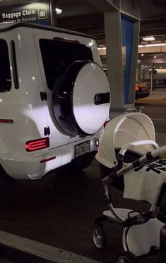 a baby stroller sitting next to a white van