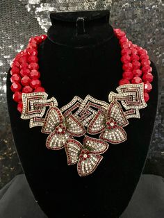 "Heidi Daus Gotta Have It Crystal Accented Red Beaded Necklace Celebrate your unbirthday with this party-perfect piece. Bold red beads and a crystal-loaded floral drop bring a refreshing quality to your favorite looks. At a women's luncheon, a quaint tea party or an elegant evening for two, this garden fresh look is sure to impress. Crystal Information This piece was made from CRYSTALLIZED™ - Swarovski Elements This piece contains Clear & Siam-color crystals Design Information Three rows of Red Rhinestone Party Necklaces, Red Costume Jewelry Necklaces For Party, Red Faceted Beads Jewelry For Party, Crystal Beaded Necklaces For Party, Glamorous Red Crystal Necklaces, Red Beaded Necklace For Party, Party Crystal Beaded Necklace With Polished Beads, Party Crystal Beaded Necklaces With Polished Beads, Crystal Beaded Necklace With Polished Beads For Party