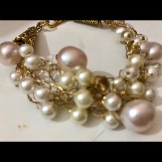 Freshwater Pearls Of Different Luster And Size Are Delicately Weaved With Non Tarnished Gold Wire. It Has Two Gold Cones To Add Texture. Some Pearls Are Small And White And Some Are Larger And Pink. Lots Of Details And A Gold Tone Clasp. Organic And On Trend. One Of A Kind. I Make Only One Piece At A Time. From A Smoke Free Home. White Pearl Drop Bracelets For Party, White Wire Wrapped Bracelets For Wedding, White Wire Wrapped Jewelry For Parties, White Wire Wrapped Wedding Bracelets, Elegant Pink Pearl Beaded Bracelets, Elegant Pink Bracelets With Pearl Chain, Handmade Gold Pearl Bracelet For Party, Pink Pearl Beaded Bracelets For Parties, Pink Pearl Bracelet For Party