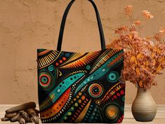 This vibrant ethnic aop tote bag is a beautiful creativity and style. Crafted with care, bohemian shoulder bag showcases captivating colorful doodle art on a sleek black background, creating a striking contrast that demands attention. The intricate design, characterized by mesmerizing wavy lines and organic shapes, draws inspiration from African patterns, exuding cultural richness and uniqueness. African tote bag is available in three convenient sizes - small, medium, and large combining versatility and functionality to suit your needs. It is spacious and practical with boxed corners creating more space and stability for whenever you want to place your bag down This ethnic weekender bag is made with high quality materials for stain and bacteria resistance. The large shoulder bag is perfect Bohemian Multicolor Bags For Gifts, Colorful Bohemian Bags For Daily Use, Colorful Bohemian Bags For Gifts, Colorful Bohemian Bags As Gifts, Colorful Bohemian Bags Perfect As Gifts, Artistic Multicolor Shoulder Bag Perfect For Gifting, Black Bohemian Shoulder Bag Gift, Colorful Doodle Art, Weekender Bags