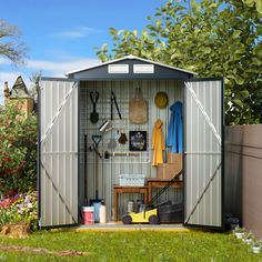 a garden shed with the doors open and tools in it