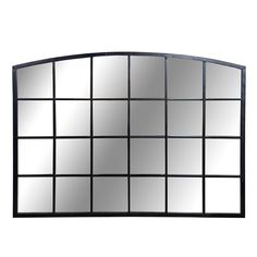 a mirror that is sitting on top of a wall next to a white wall with black squares