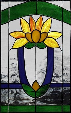 a stained glass window with a yellow flower on it