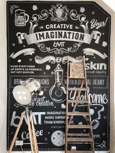 a chalkboard with some writing on it next to a wooden ladder and light bulb