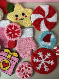 several handmade christmas ornaments are displayed on a counter top, including candy canes and candies