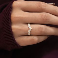 a woman's hand with a diamond ring on it