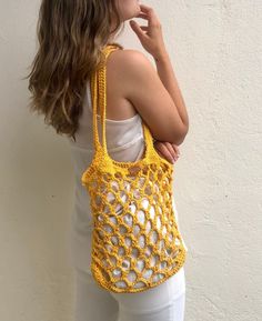 Crochet market bag handmade in a bright yellow color, perfect for summer with long and strong straps, perfect for beach days or to give an extra touch to your summer outfits. This net shoulder bag is handmade in 100% cotton, every bag is made to order, giving an extra attention to the details what makes the pice unique and timeless. Designed to be as special as her new owner. The bag includes a cotton pouch so you can keep your belongings safe! WHICH IS THE BAG SIZE? Check of the bag fits your p Yellow Crochet Beach Bag, Yellow Crochet Shoulder Bag For Vacation, Yellow Crochet Tote Bag For Summer, Yellow Crochet Bag For Summer, Summer Crochet Bag For Shopping, Spring Yellow Crochet Bag, Yellow Crochet Bag For Spring, Yellow Crochet Tote Bag For Spring, Handmade Yellow Summer Shoulder Bag