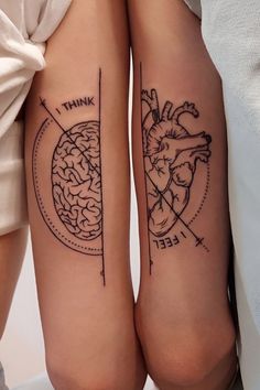 two people with tattoos on their legs and one has an image of a heart in the middle