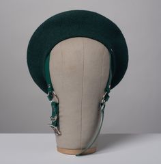 This full-size wool forest green beret hat is outfitted with harness straps that buckle under the chin. Nice and structured, quality woven with a nice tight weave. Fits up to a 23" head size. Material is 100% wool felt, with an 11.5" diameter. Straps are glossy deep teal green PVC. All pieces are MADE TO ORDER. Please contact us if you have any questions or requests about sizing! Every piece is made by hand in Seattle, WA. Please allow approximately 2-3 weeks for making time. During sales turnar Handmade Adjustable Hat Headpiece, Vintage Handmade Adjustable Felt Hat, Green Beret Aesthetic, Novelty Green Adjustable Hat, Adjustable Green Hat Headpiece, Green Beret, Plush Bags, Classic Style Outfits, Beret Hat