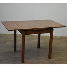 a wooden table sitting on top of a hard wood floor