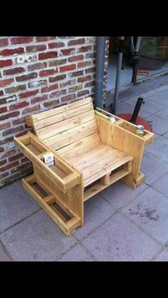 a wooden bench sitting next to a brick wall