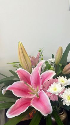 a vase filled with pink and white flowers