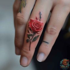 a woman's hand with a rose tattoo on it and an arrow in the middle