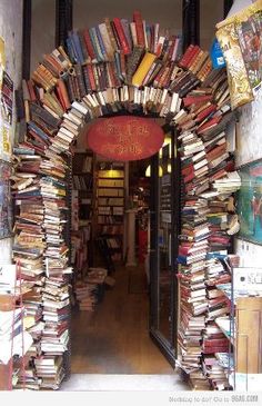 an arch made out of books is shown in the doorway to a book store filled with books