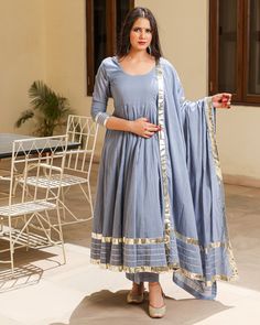 This 3 Pc anarkali Suit set is designed in mul-mul cotton fabric with Gota work mul-mul Dupatta. Kurta Length - 50, Mul-mul Cotton, Gota work With on hem & sleeves. Pant length - 38, Mul-mul cotton. Dupatta - Mul-mul cotton, gota work on edges. Fabric - mul-mul cotton. Color - Grey CARE: dry clean only. Shipping - 10-12 working days. DISCLAIMER - The color of the product may be differ from the image 10-12% due to camera and lights and screen settings of device. Anarkali Kurta Designs Women, Festive Cotton Lawn Suit With Gota Work, Grey Anarkali Suits, Cotton Palazzo Set With Gota Work For Eid, Wedding Cotton Lawn Suit With Gota Work, Wedding Cotton Salwar Kameez With Gota Work, Cotton Salwar Kameez With Gota Work For Navratri, Wedding Cotton Churidar With Gota Work, Blue Cotton Anarkali Set With Gota Work