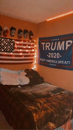 a bed with an american flag on the headboard and lights strung from above it