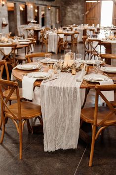 the tables are set with white linens and place settings