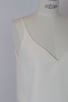 Clean tank top made of ivory-colored crepe fabric Special feature: fully lined (including straps) - no closure, slip top, therefore loose fall - deep V-neckline - Color: dark white/ivory Dimensions: Chest circumference 88 cm Top length (shoulder to hem edge) 48 cm Dark White, Slip Top, No Closure, Crepe Fabric, Bridal Gowns, Bridal Dresses, Special Features, Wedding Gowns, Loose Fitting