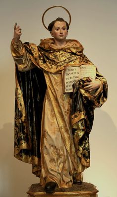 a statue of jesus holding a piece of paper