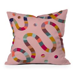 a pink pillow with colorful shapes on the front and back of it, which is shaped like a question mark