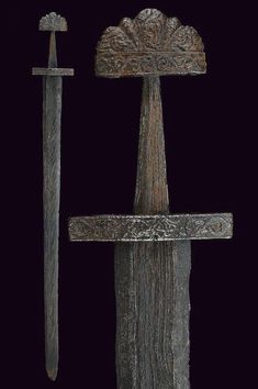 an old wooden cross is displayed against a black background