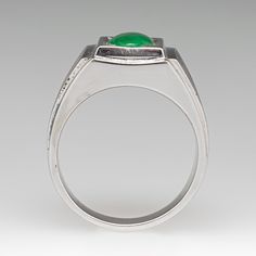 This awesome mens ring is centered with one (1), bead set, oval cabochon cut natural jadeite jade. The shoulders of the ring feature a Florentine finished with step-down bright polished edges. The ring measures 12.1mm at the top, rises 6.6mm above the finger, tapering to 4.0mm wide and 1.2mm thick at the base of the shank. The ring is currently a size 8. Modern Cabochon Emerald Ring For Formal Occasions, Modern Emerald Signet Ring For Formal Occasions, Classic Jade Jewelry, Classic Cabochon Emerald Ring For Formal Occasions, Modern Emerald Oval Cabochon Ring For Anniversary, Modern Cabochon Signet Ring For Anniversary, Timeless Green Signet Ring With Polished Finish, Classic Jade Rings For Formal Occasions, Modern Jade Jewelry For Anniversary