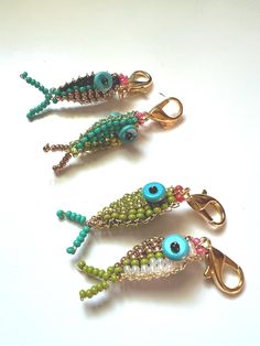 three different types of beaded keychains with eyes and beads hanging from them