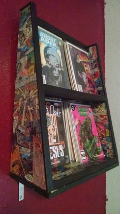 a red wall with a shelf filled with comic books and magazines on it's sides