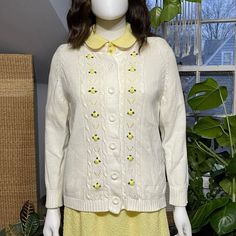 Brand: Bonnie Brook- From the 1970's- In Excellent Condition! Gorgeous Cream Colored Eyelet Knit Sweater with Yellow Rosette Detail- 100% Acrylic Knit- Button Front Closure. Adorable & Rare! **Vintage Size M- Measurements are: Chest & Waist 36"/ Shoulder to Shoulder 15"/ Sleeve Length 23"/ Body Length 25". Vintage Collared Sweater For Winter, Retro Collared Winter Sweater, Retro Collared Sweater For Winter, Vintage Spring Sweater With Buttons, Vintage Fitted Sweater For Spring, Retro Collared Sweater For Fall, Retro Knit Outerwear For Spring, Retro Knit Sweater For Spring, Spring Collared Cardigan With Buttons